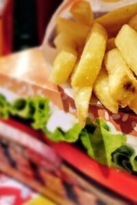 Crispy french fries served on a fast food tray with vibrant packaging.