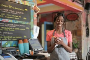 Smiling waitress taking notes in a vibrant restaurant setting.